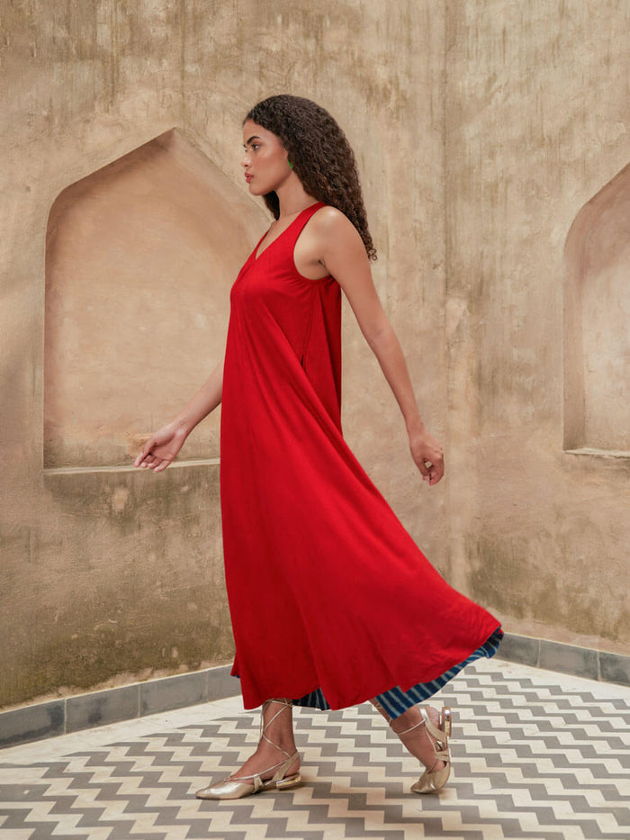 Woman wearing a red Pinklay sleeveless maxi dress.