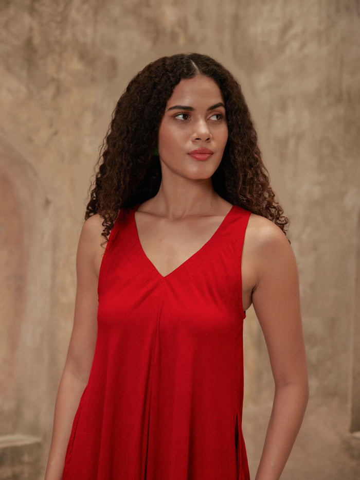 Woman wearing a red Pinklay sleeveless maxi dress.