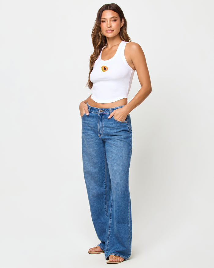 Side view of model wearing the LSPACE Ash Tank in papaya.