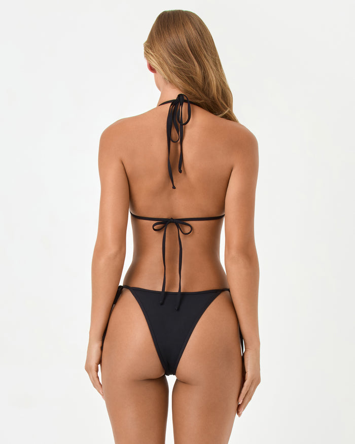 Back view of a model wearing the LSPACE black Aspen Bikini Top, showing the triangle tie-back detail.