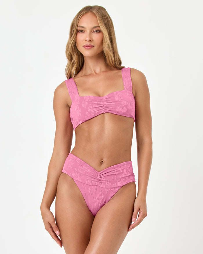 Front view of a model wearing the LSPACE hottest pink Bardot Bikini Bottom with a matching Marlee bikini top.