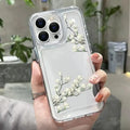 a woman holding a white flower phone case