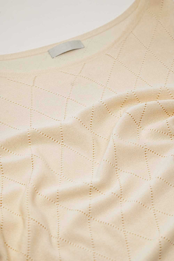 Beige sweater in argyle print with boat neck