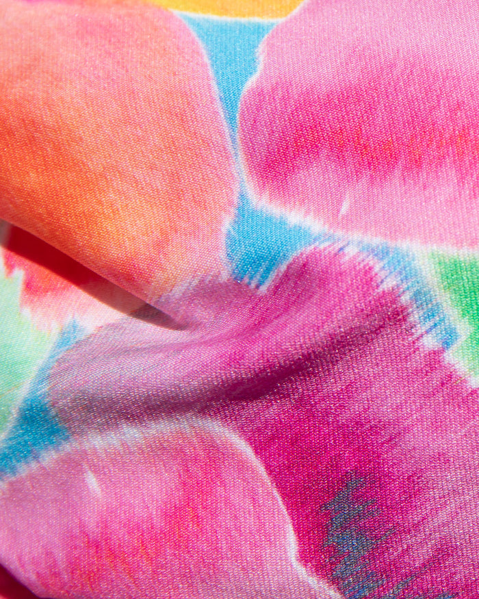 Close-up of pink, orange, blue, and teal floral print fabric used in the LSPACE Flower Play Belle Bikini Top.