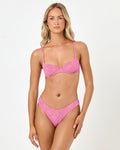 Front view of a model wearing the LSPACE hottest pink Belle Bikini Top with a floral-textured balconette silhouette.