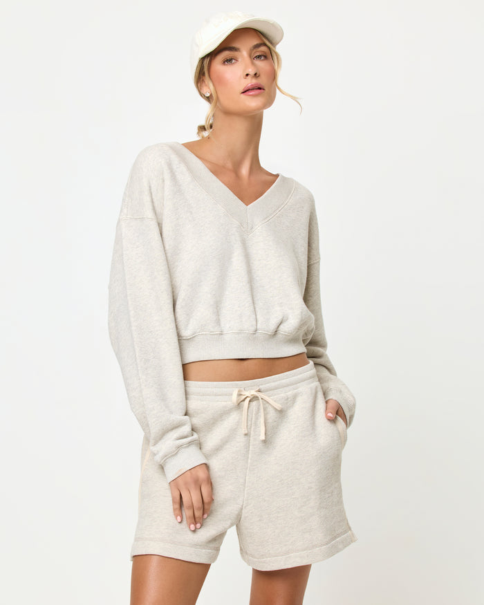 Heather Gray | Badge:New Arrival_#B2AC88_#ffffff'

LSPACE Vaughn sweatshirt and Bennett Short in heather gray, close-up detail view on model.