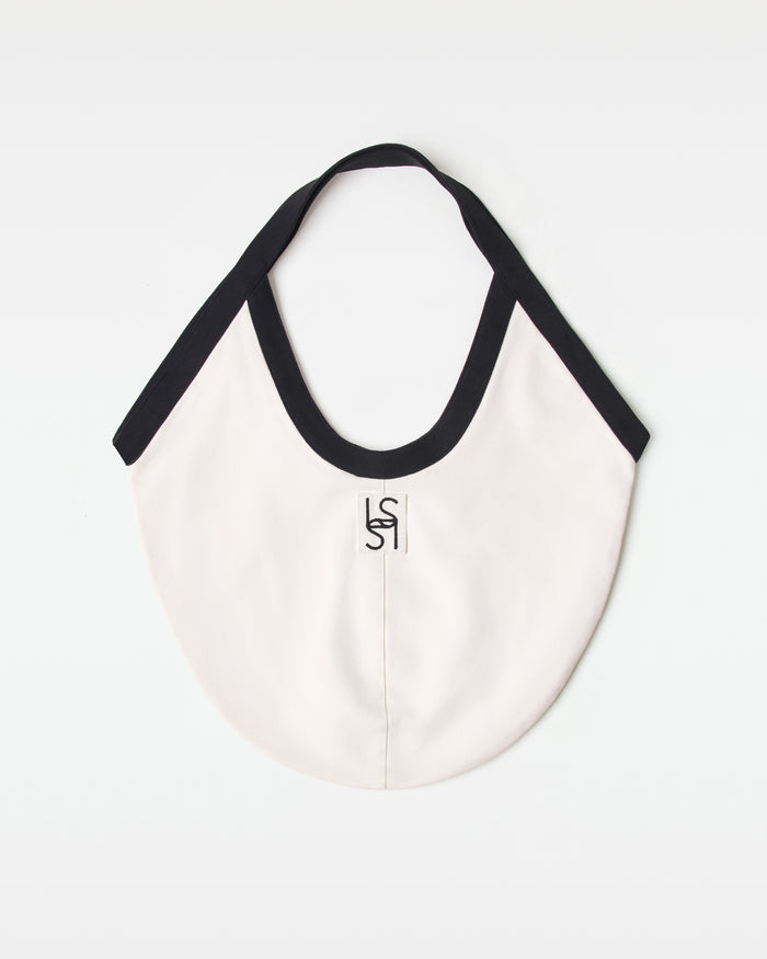 Off-model back view of the black and cream Bronte Canvas Bag showing a L*SPACE logo.