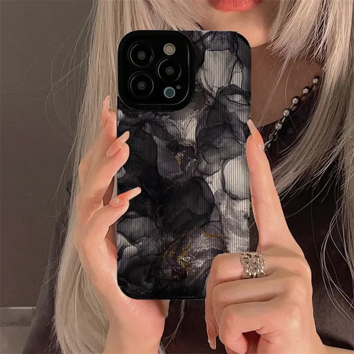 a woman holding up her phone case