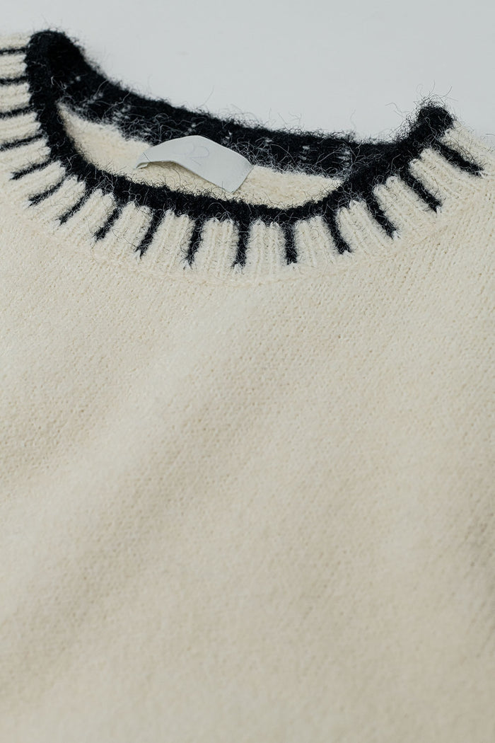 Fluffy cream sweater with ribbed detail at neck and hem