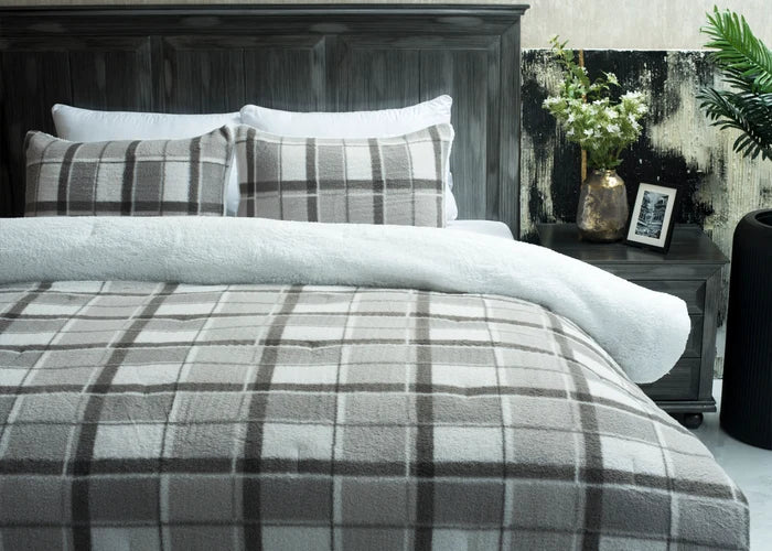 Grey plaid bedding set with plush comforter and white-edged pillow shams