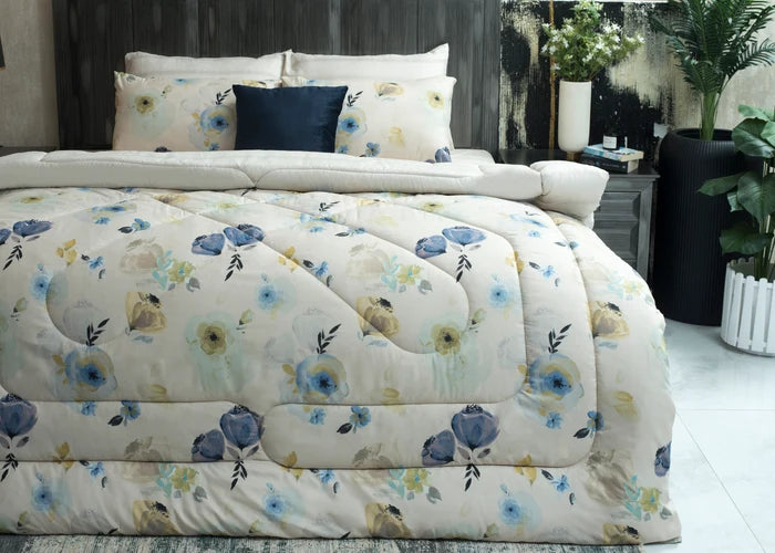 Cream comforter set with blue floral pattern and dark blue accent pillows