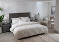 Off-white duvet cover and matching striped pillows on a bed