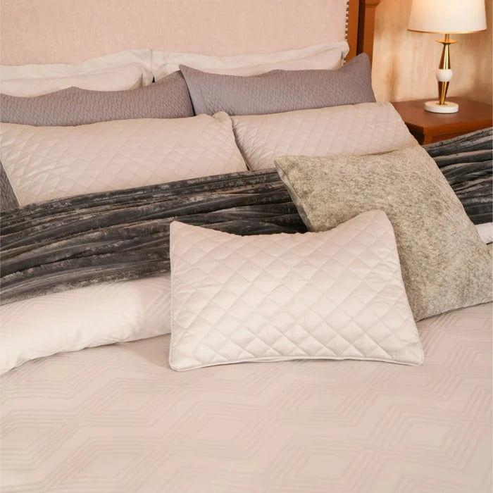 7-piece duvet cover set with quilted white duvet, gray shams, and textured accent pillows
