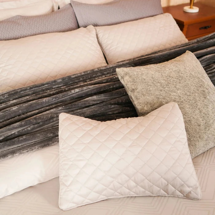 Quilted duvet cover set with white sham pillows and silver-gray striped bedding