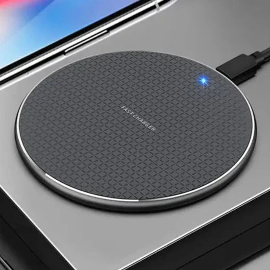 a person holding a wireless device with a charging pad attached to it
