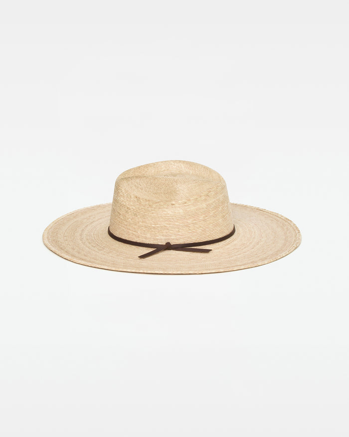 Off-model side view of the natural Isla Hat showing the wide brim and woven straw construction.