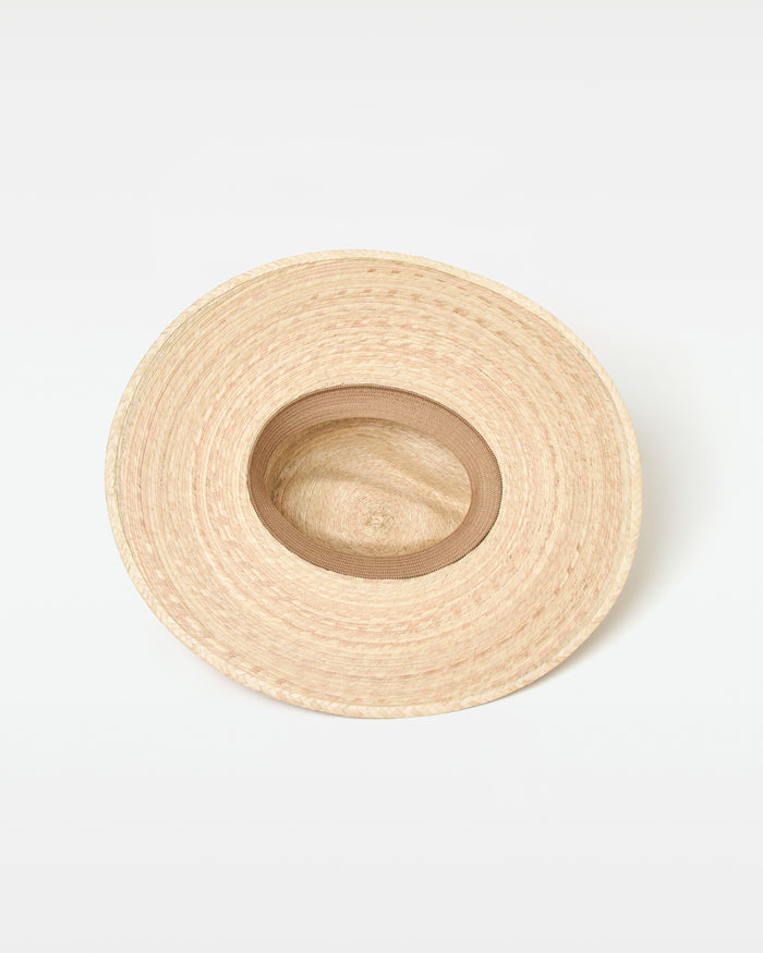 Interior view of the natural Isla Hat showing the woven straw construction and interior lining.