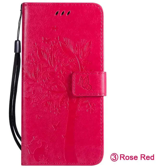 the back of a red leather wallet case with a flower design