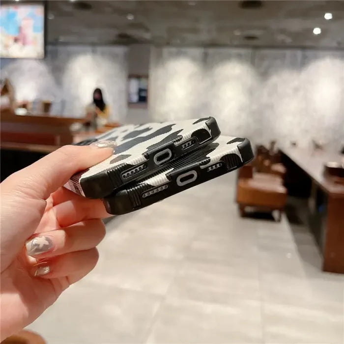 a person holding a cell phone in their hand