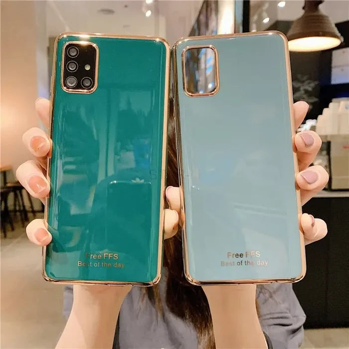 a woman holding up a green phone case