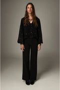 Shop the Maison Hotel Catherine Blouse in Blackout at Dotique. An embroidered black blouse with a cropped shape, ruffled hem and mother-of-pearl buttons.