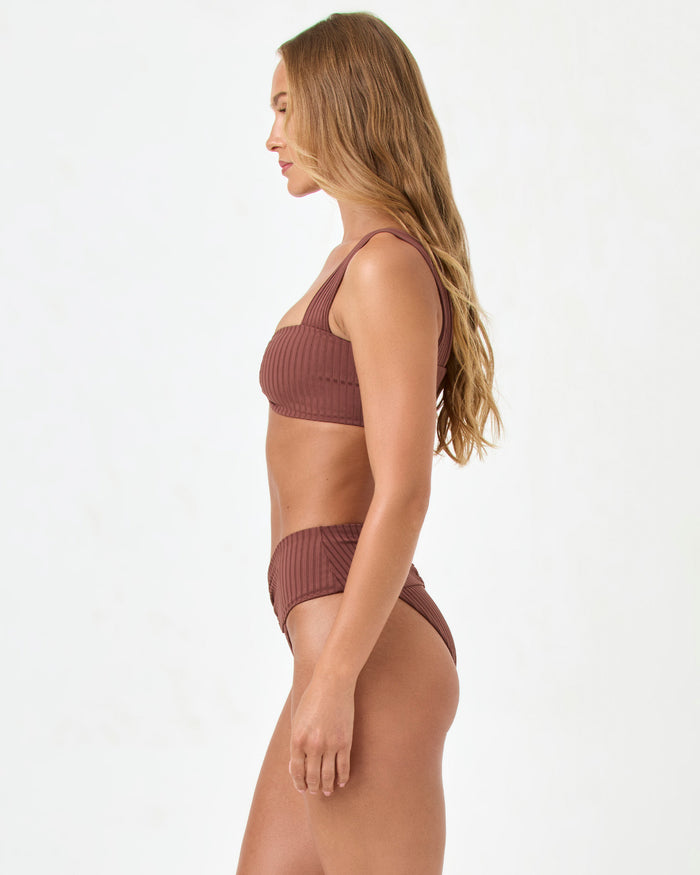 Side view of a model wearing the LSPACE cafe Marlee Bikini Top with matching cafe Bardot Bikini Bottom.