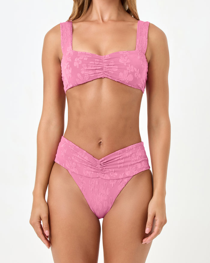 Close-up front view of a model wearing the LSPACE hottest pink Marlee Bikini Top with ruched front detail, paired with the Bardot Bikini Bottom.