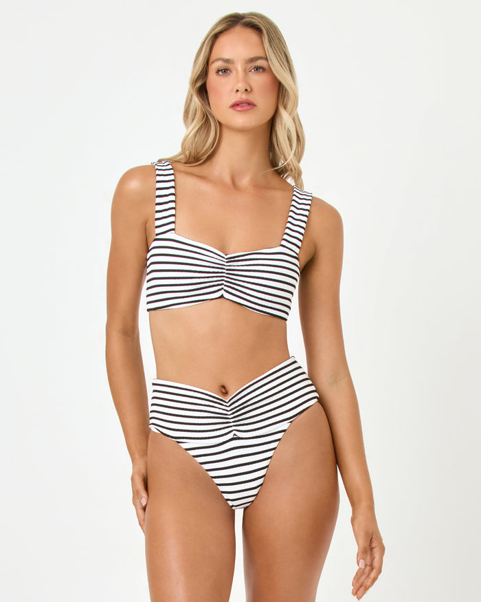 Front view of a model wearing the LSPACE sail along stripe Marlee Bikini Top with ruched front detail, paired with the Bardot Bikini Bottom.
