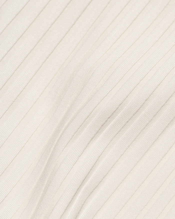 Close-up detail of the cream ribbed eco-friendly fabric texture of the LSPACE Mercer Bikini Bottom, off-model.