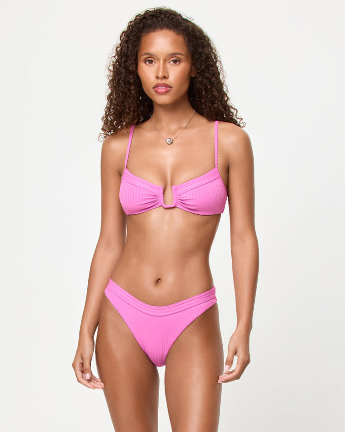 Front view of a model wearing the LSPACE Sweetheart Mercer Bikini Bottom with ribbed fabric and banded waistband.