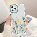 a woman holding a phone case with flowers on it