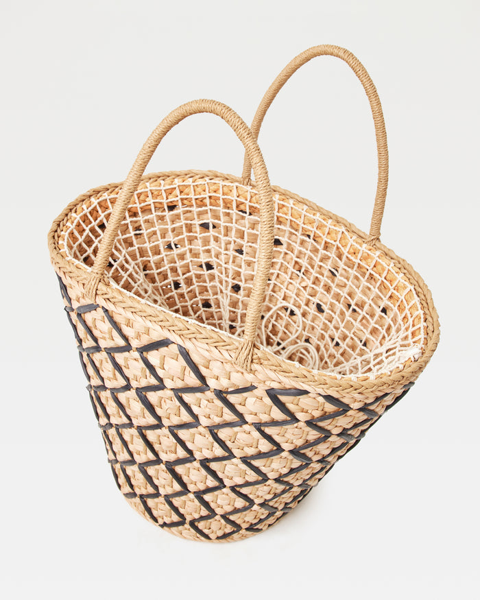 Angled top-down view of the Palma Nights Bag in natural-black showing the open interior and the natural-black lattice weave on the exterior.