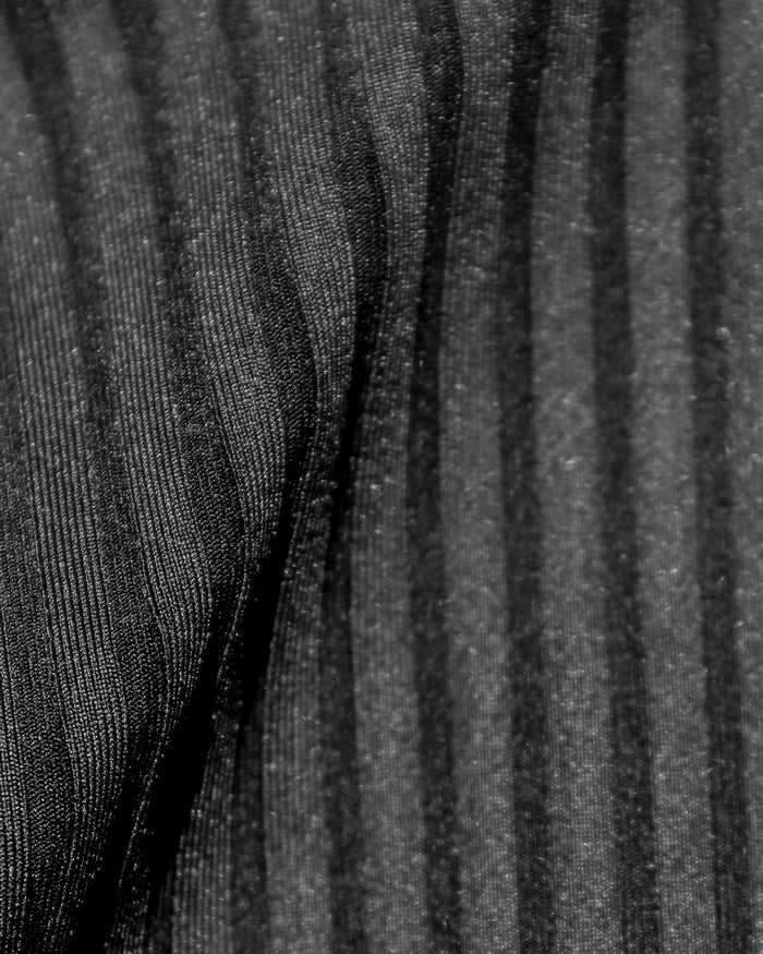 Close-up detail of the black ribbed eco-friendly fabric texture of the LSPACE Peyton Bikini Top, off-model.