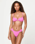 Front view of a model wearing the LSPACE Sweetheart Peyton Bikini Top with ribbed fabric and center front twist detail.