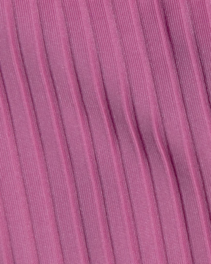 A close-up of a pink ribbed fabric with vertical pleats and a fine woven texture.