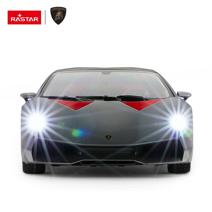 Rastar 1:14 Lamborghini Sesto Elemento RC car in dark grey shown front-on with both bright LED headlights illuminated, highlighting the aggressive front splitter and Lamborghini badge.
