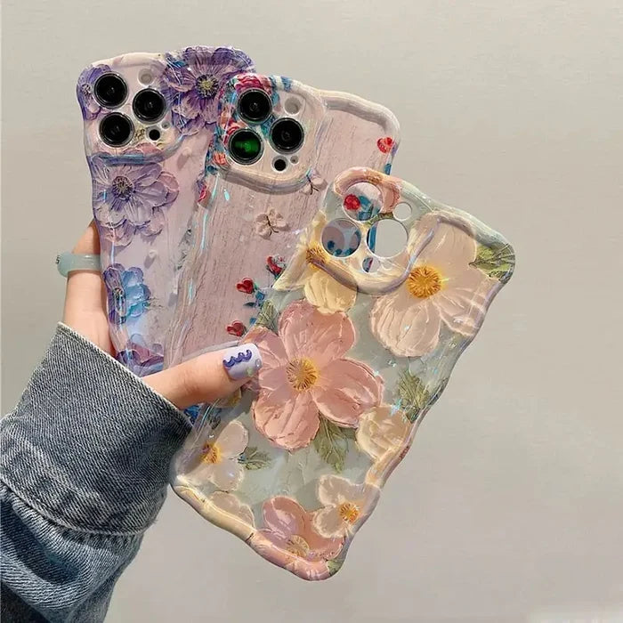 a woman holding a phone case with flowers on it