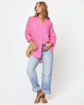 Front view of a model wearing the LSPACE Rio Tunic in hottest pink, an oversized linen button-up shirt with a relaxed fit and three-quarter sleeves.