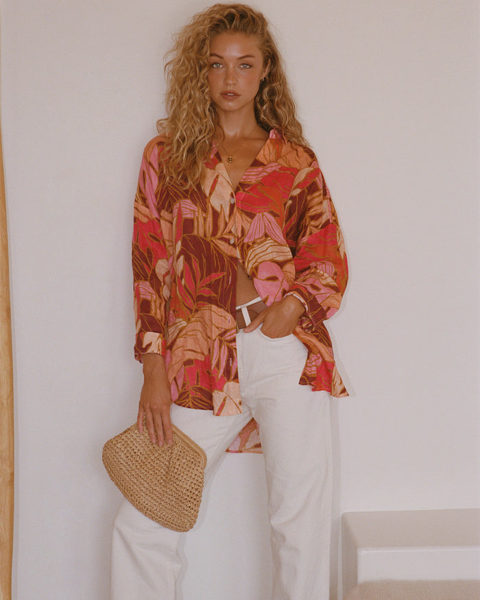 Lifestyle image of model wearing the LSPACE Rio Tunic in leaf it to me, a floral-print tunic.