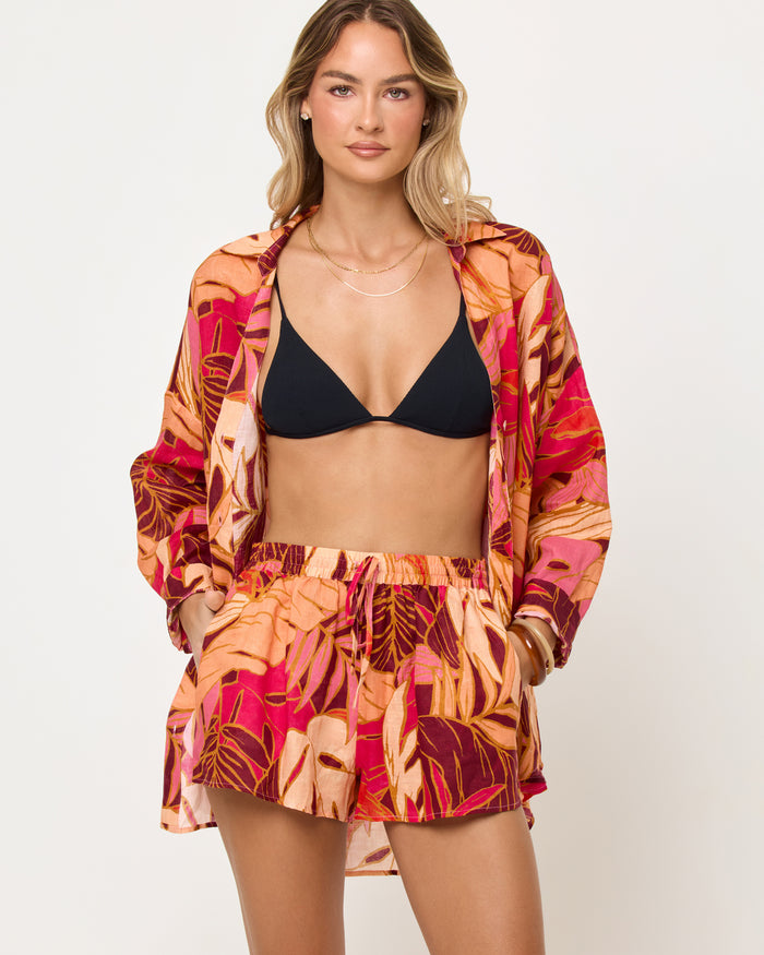 Close-up of the LSPACE Rio Tunic in leaf it to me showing the hem and leaf print detail.
