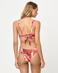 Back view of a model wearing the LSPACE Leaf It To Me Rocky Bikini Bottom with tropical leaf print.