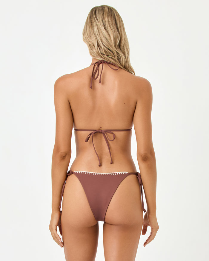 Back view of a model wearing the LSPACE cafe Samba Bikini Bottom with matching triangle top and cream trim detail.