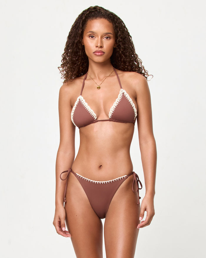 Front view of a model wearing the LSPACE cafe Samba Bikini Top with cream trim detail and matching bikini bottom.