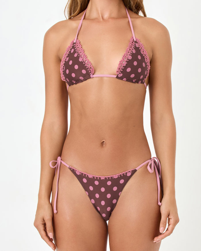 Close-up front view of a model wearing the LSPACE stripe-dot Samba Bikini Top in a brown and pink polka dot print with matching polka dot bikini bottom.