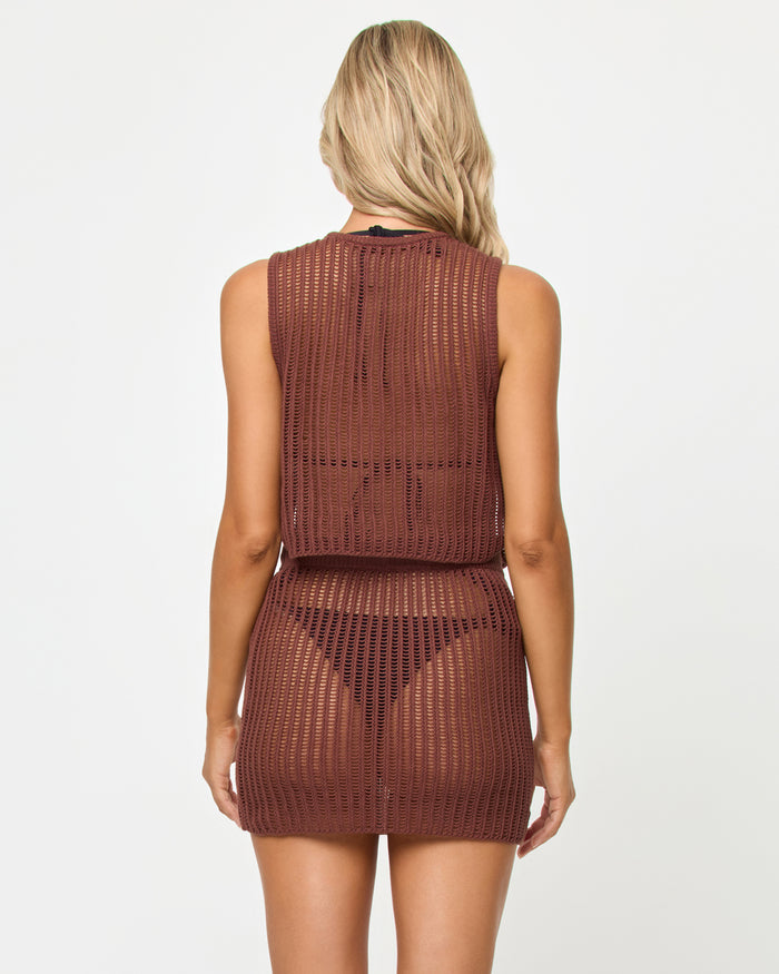 Back view of a model wearing the LSPACE Sander Top in cafe, showing the open crochet weave back, styled with the matching Sander Skirt.