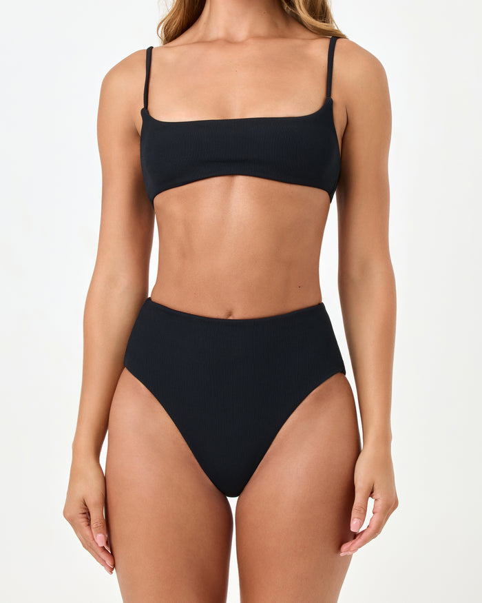 Close-up front view of a model wearing the LSPACE black Soleil Bikini Bottom with the Presley Bikini Top.