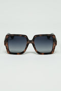 Sunglasses with a brown print frame and black temples