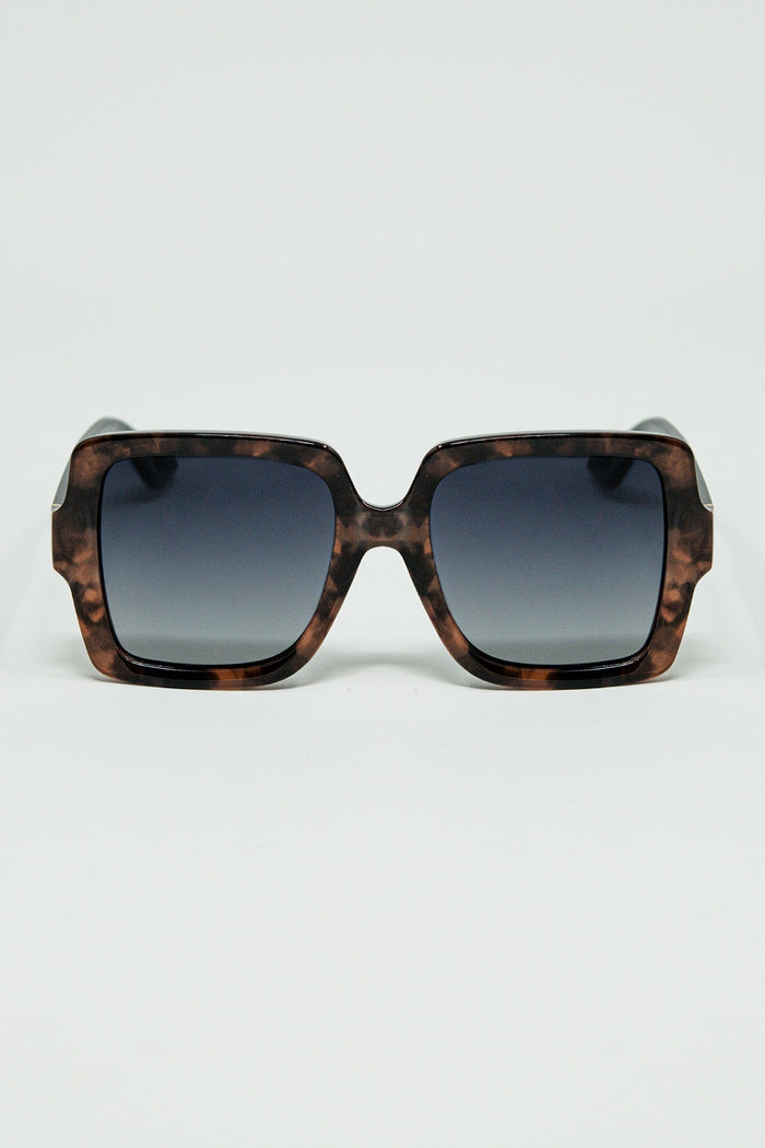 Sunglasses with a brown print frame and black temples
