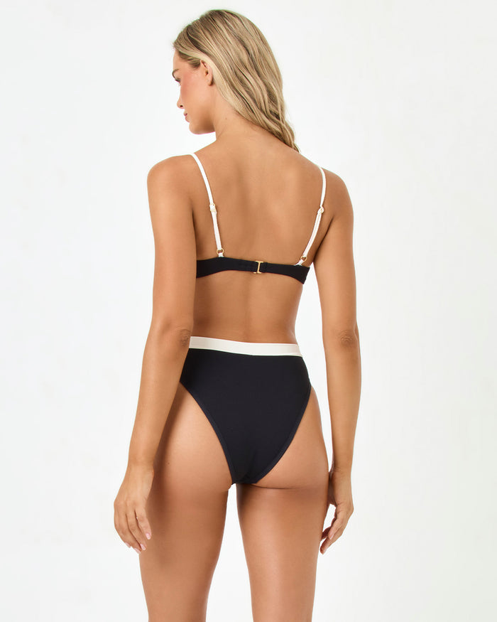 LSPACE Sunrise Shell bikini top in black-cream, back view on model.