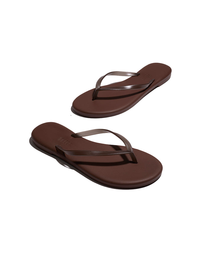Angled view of both brown TKEES Aqua Sandals showing the sole and side profile.